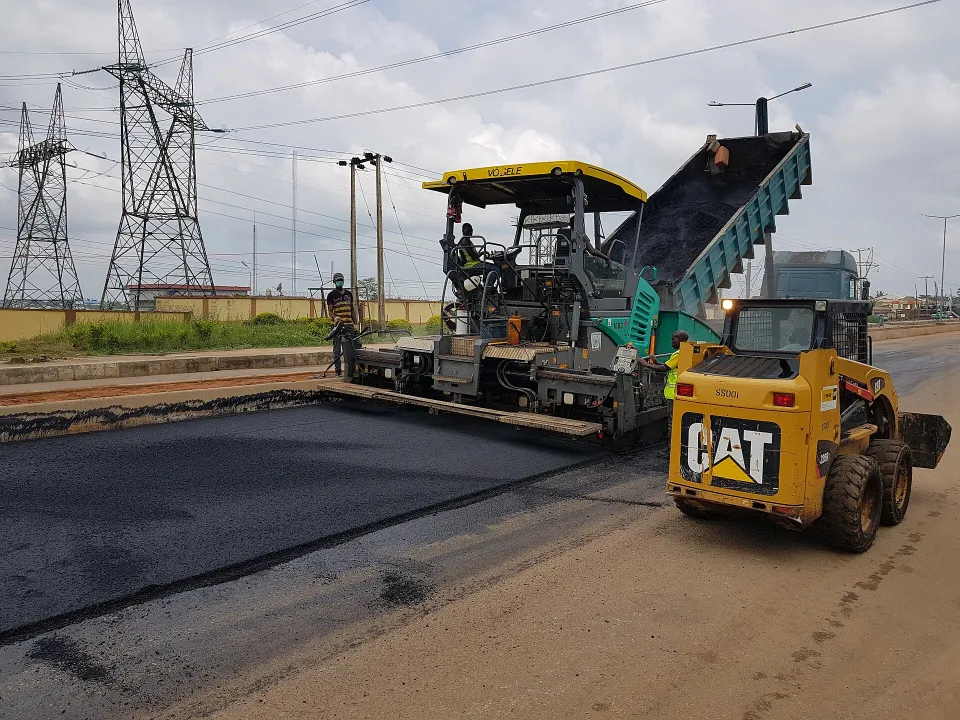 Asphalt paver laying a road surface