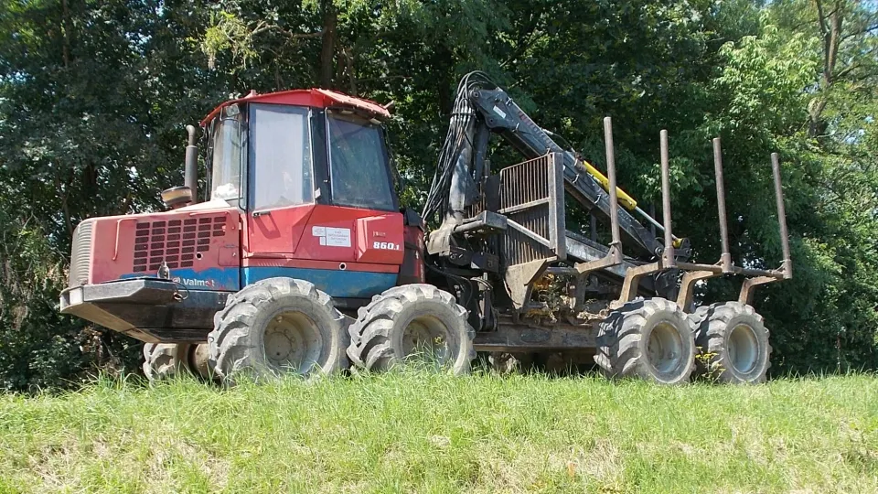 Forwarder carrying logs in a forest