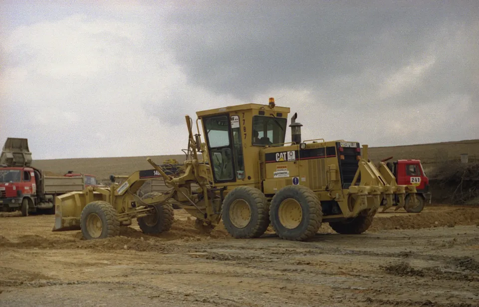 Motor grader shaping a gravel surface