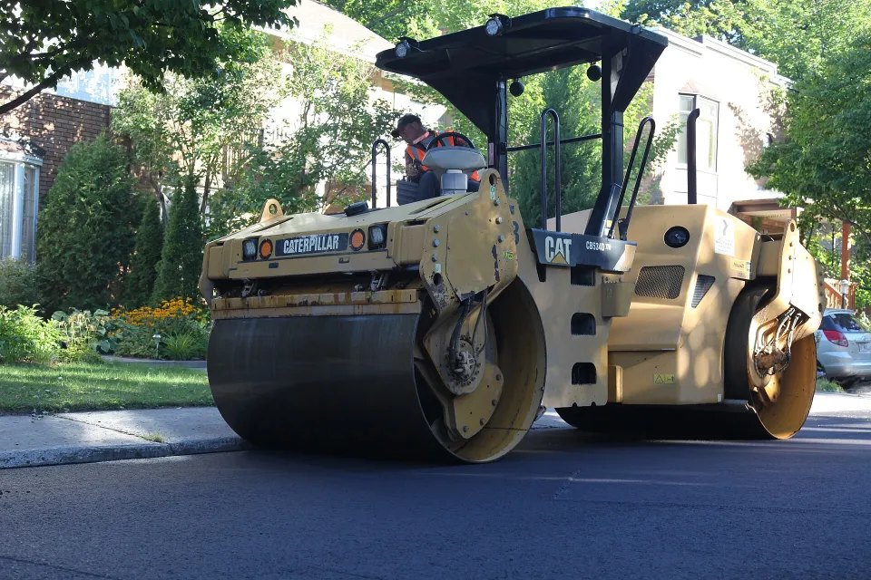 Tandem road roller compacting asphalt