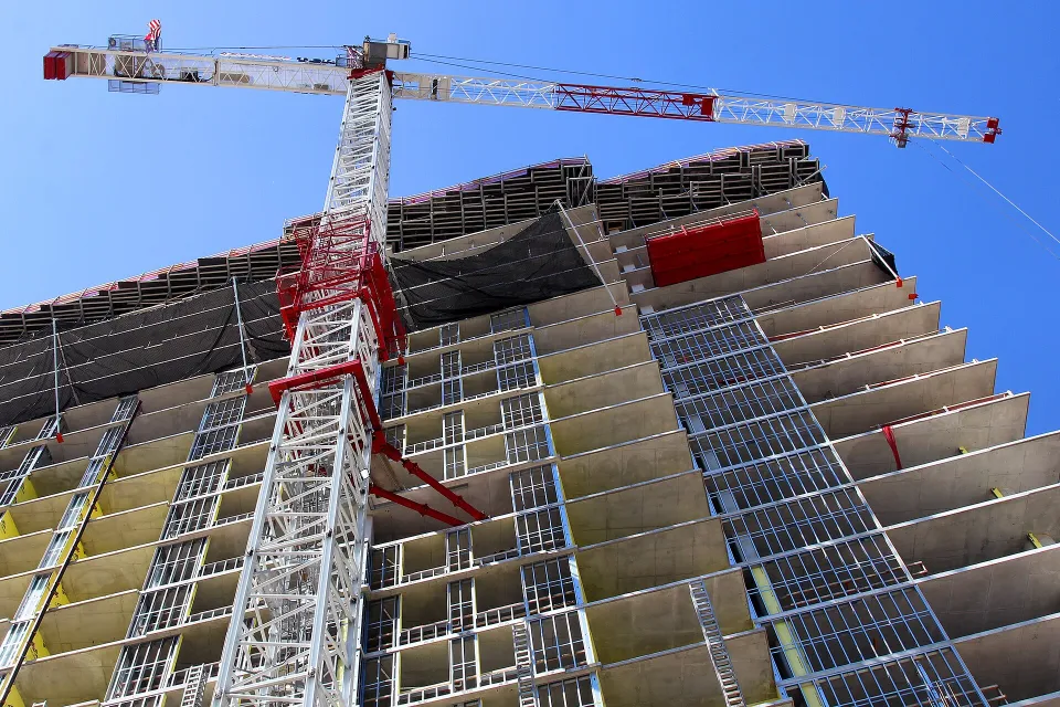 Tower crane beside a high-rise building under construction