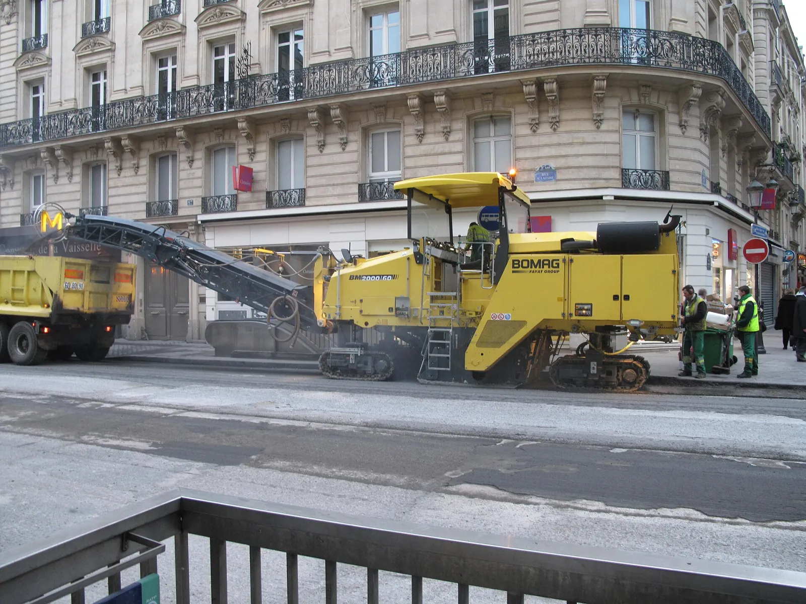 Cold milling machine removing asphalt on a Paris street