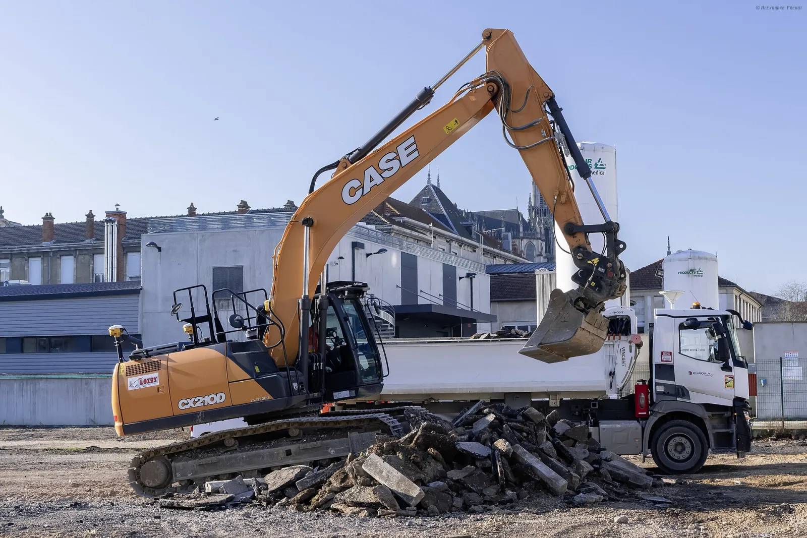 CASE CX210 crawler excavator loading demolition debris (D-series pictured)