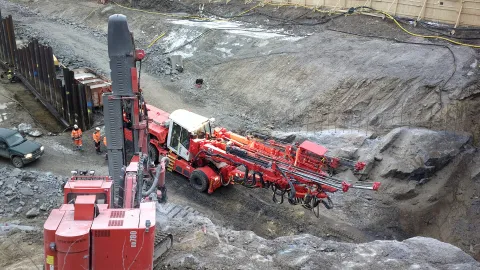 Sandvik surface drill rig on a tunnel construction site in Helsinki