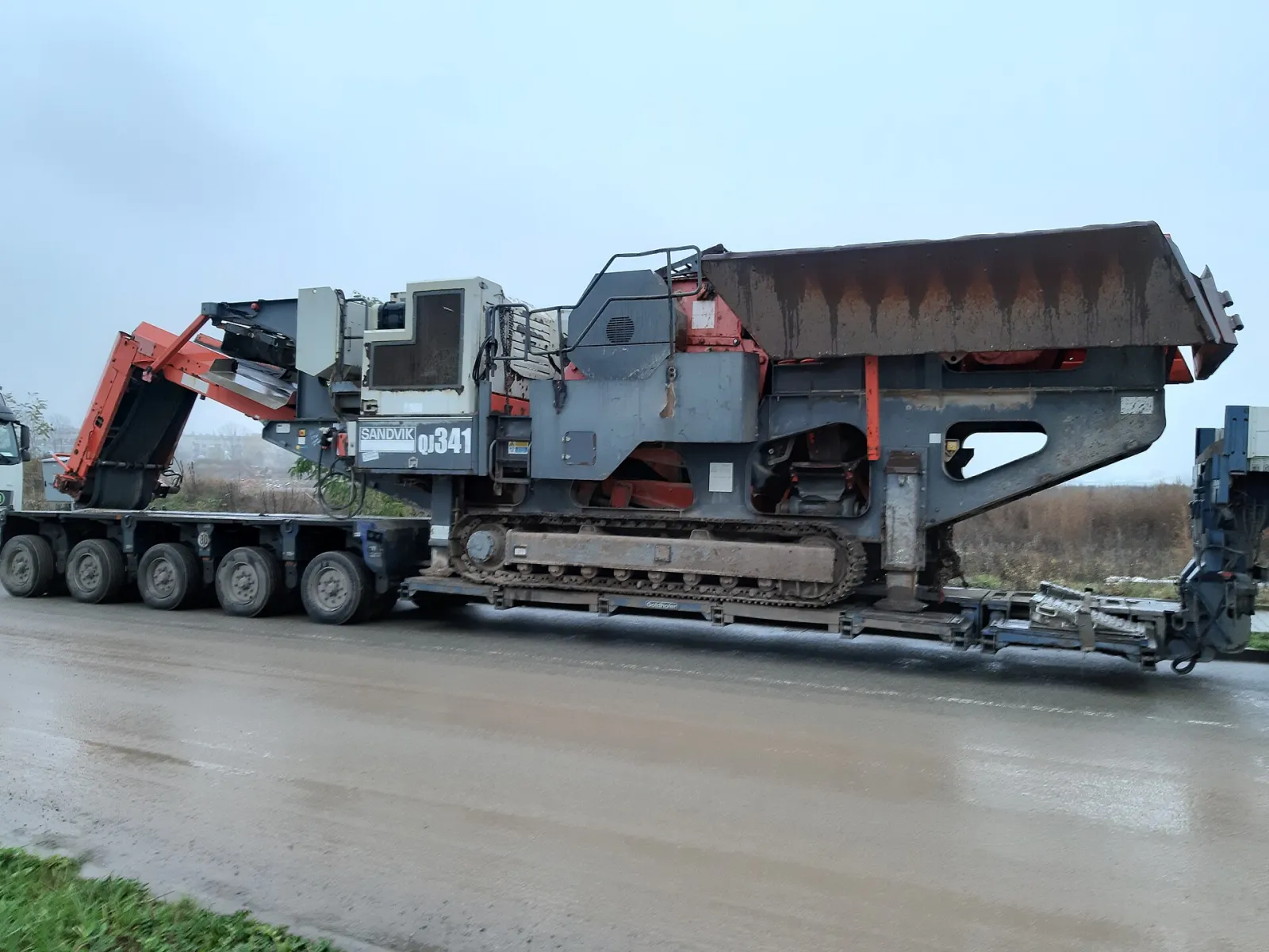 Tracked mobile jaw crusher on a low-loader