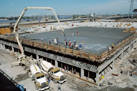 Concrete boom pump placing concrete on a parking garage deck