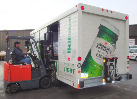 Cushion-tire forklift loading a beverage delivery truck