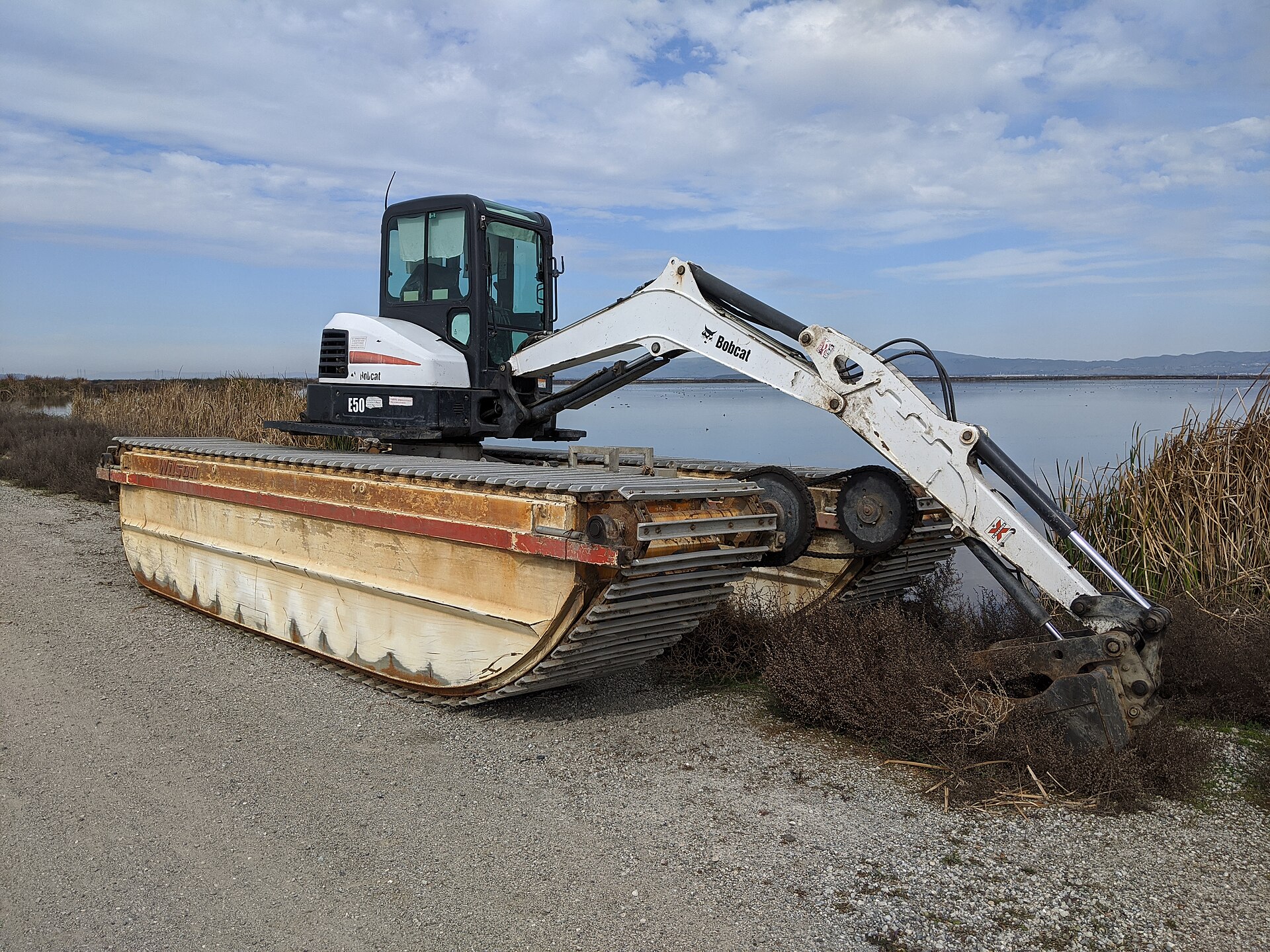 Compact excavator with wide tracks